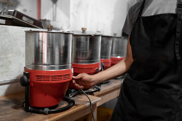 Anonymous worker setting chocolate tempering machine