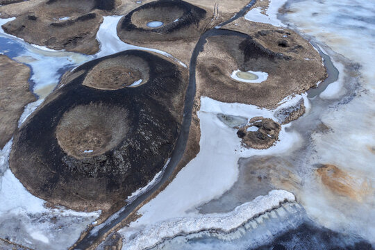 Volcanic craters near frozen lake