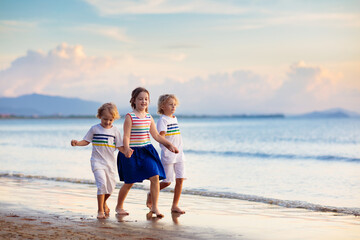 Kids play on tropical beach. Sand and water toy.