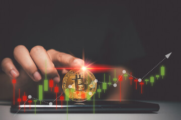 Businessman's hands touching bitcoins, trading cryptocurrencies online, visual screen showing fluctuations in charts