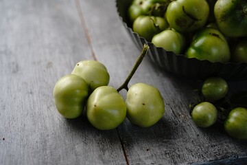 Homegrown green tomatoes still life, selective focus