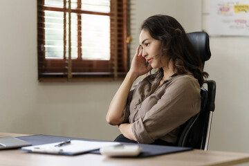 Fototapeta na wymiar Depressed tired asian businesswoman, stressed at office workplace.