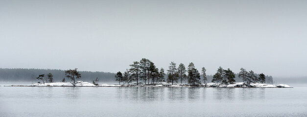 Panoramic view of late autumn landscape, first snow in the ground. Lake Pielinen, Eastern Finland.