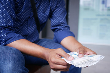 Close up of man hand counting 100 us dollar cash 