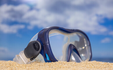 A snorkel mask on the beach