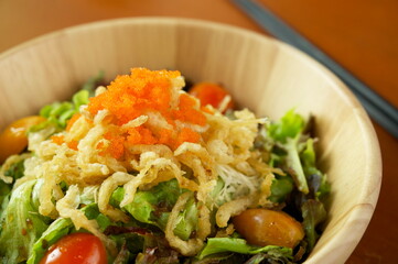 Shirauo (Japanese icefish) Salad with orange fish roe on top in wooden dish.