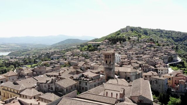 Aerial view of the historical center of Narni (Terni, Umbria, Italy) towards the Albornoz castle on a summer day. Tilt up, drone shot.