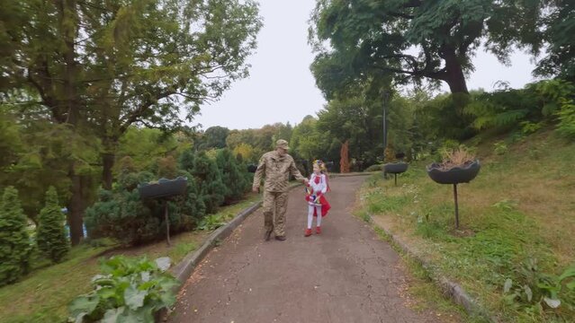 Ukrainian military dad returned home to his daughter. The military man and the little girl go hand in hand.