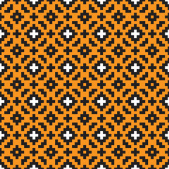 Black and white cross-stitch knitting pattern on orange background. Black and white square dots on orange backdrop. Monochrome fabric pattern design for sale. Knitting handicraft art.
