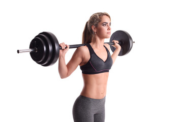 smiling sporty woman exercising with barbell