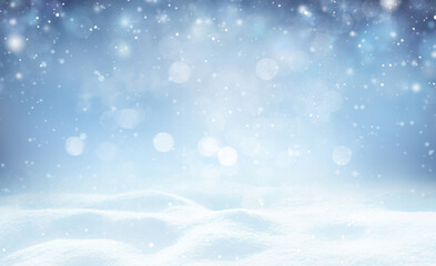 Winter background - sparkling falling snow against a dark blue sky and white snowdrifts.
