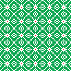 Red and white cross-stitch knitting pattern on green background. Red and white cloth pattern on green backdrop. Christmas color theme fabric pattern design for sale.  Knitting handicraft art.