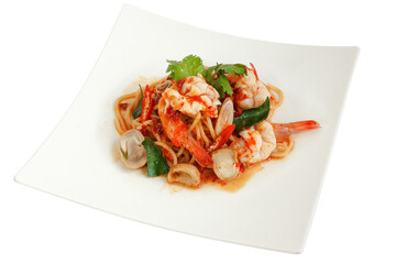 Thai Seafood Spaghetti (Tom Yum Goong) on a white plate. Thai food.