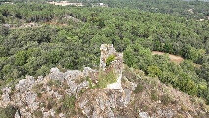 Fototapeta na wymiar Aerial shot of a medieval tower on a cliff , located at Sande, Cartelle, Ourense, Spain