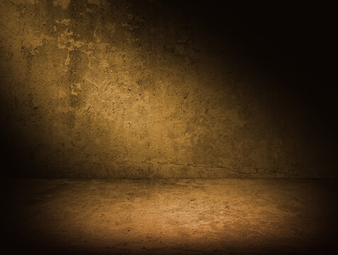 Empty concrete room with warm tone lightning. Dark concrete background with spotlight for mock up or product display. Urban photography studio backdrop.