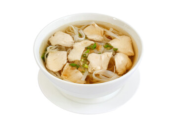 Chicken soup with noodles and vegetables in white bowl.