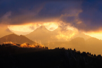 dramatic sunset with clouds in the Alpine foothills of Fribourg