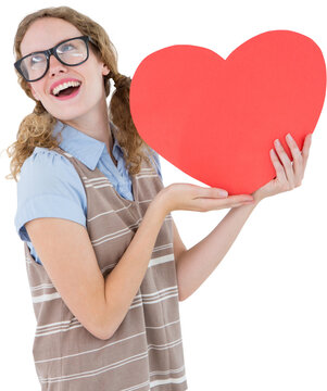 Vertical image of happy caucasian woman in glasses holding red heart