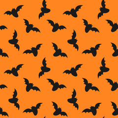 Seamless pattern with bats for halloween. Black flat silhouette elements on a orange background. Colorful vector illustration.