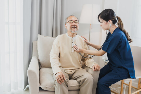 Asian nurse, doctor woman assisting checking heart rate stethoscope of Senior Asian patient man