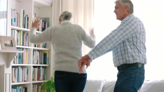 Energetic, happy and old couple dance in home together, enjoying retirement. Music, dancing and senior couple in living room, celebrating retired life. Grandparents, family and dancer elderly people