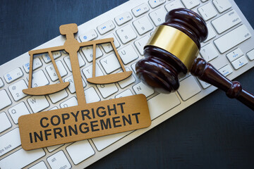 Copyright infringement phrase on the plate, keyboard and gavel.