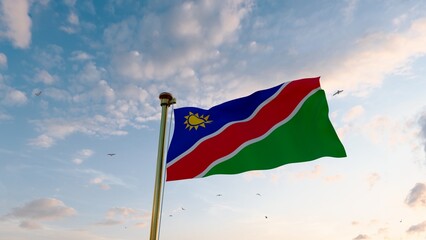 Flag of Namibia waving in the wind, sky and sun background. Namibia Flag. 8K Ultra Hd.