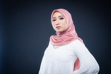 Portrait of a beautiful female Muslim model wearing hijab, a lifestyle apparel for Muslim women isolated. Modern hijab fashion concept.