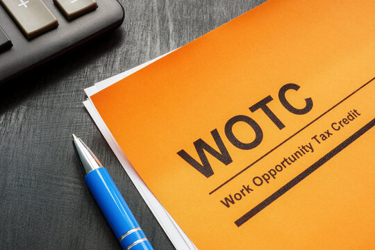 Work opportunity tax credit WOTC application, pen and notepad.