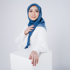 Portrait of a beautiful female Muslim model wearing hijab, a lifestyle apparel for Muslim women isolated. Modern hijab fashion concept.