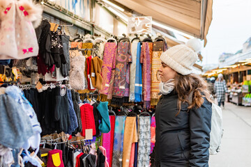 Fototapeta na wymiar Tourist shopping in street market in Vienna, Austria.