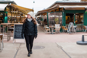 Caucasian woman traveler in Vienna market. She is shopping and travel.