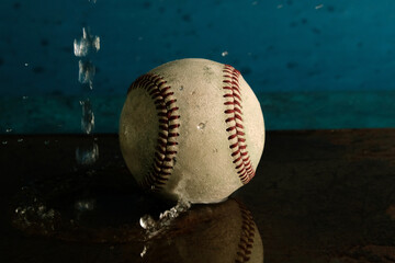 Baseball rain game concept with ball in water.