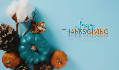 Cheerful Happy Thanksgiving flat lay background with blue and orange pumpkins for greeting of...