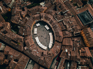 Landmarks of Tuscany, Italy - Piazza dell'Anfiteatro - The Famous Amphitheater Square in Lucca city. Aerial view landscape. Tuscany. Italy. View from above. Drone Image - obrazy, fototapety, plakaty