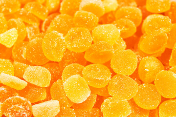 Background of orange jelly beans. Sweet food. Unhealthy concept