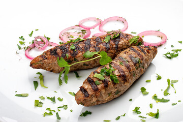 Pork kebab with greens. Isolated on a white background