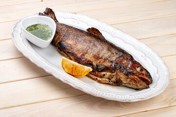 Grilled mackerel with butter and herbs. On a light background.