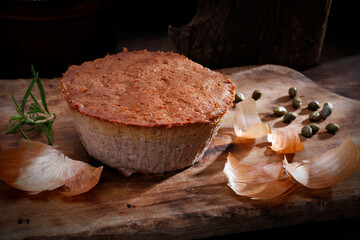 Homemade, baked meat pate, close-up. Rustic composition with a meat product on a wood chopping...