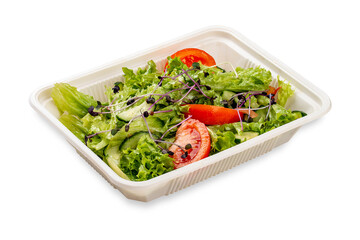 Salad with fresh vegetables and microgreens. In a plastic container. Food to go. On a light background.