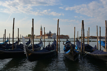 Gondolas in lagoon of Venice on sunrise, Italy