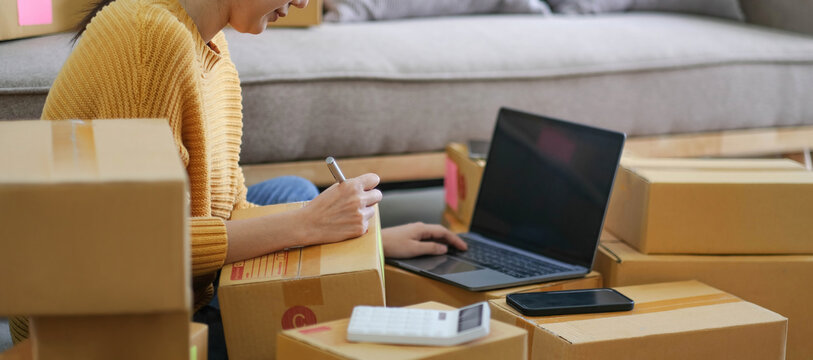 Starting small businesses SME owners female entrepreneurs check online orders to prepare to pack the boxes, sell to customers, sme business ideas online.