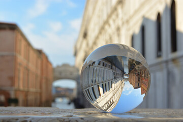 Glass ball lying on the ceiling in front of the ponte dei sospiri - bridge of sighs in early morning