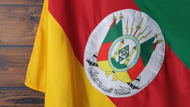 State flag of Rio Grande do Sul, Brazil, on wooden background. Gaucho day, farroupilha week.