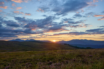 Fototapeta na wymiar A breathtaking Scottish sunset over the glens and hills