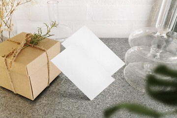 Clean minimal business card mockup floating on top granite with vase and craft box