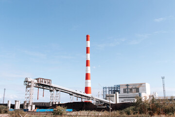 Fototapeta na wymiar Coal-fired thermal power plant with smoke from pipes