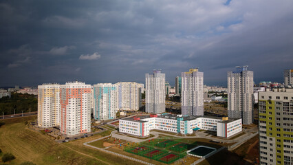 Fototapeta premium Modern urban architecture. Multi-storey buildings with infrastructure. Densely populated urban area. Overcast weather. Aerial photography.