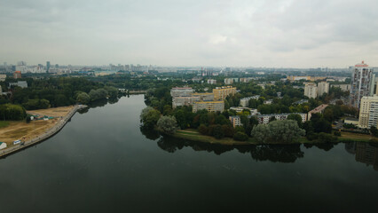 Fototapeta na wymiar Lake in the city park. Urban landscape. Dormitory area of a big city. Aerial photography.