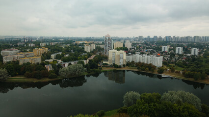 Fototapeta na wymiar Lake in the city park. Urban landscape. Dormitory area of a big city. Aerial photography.